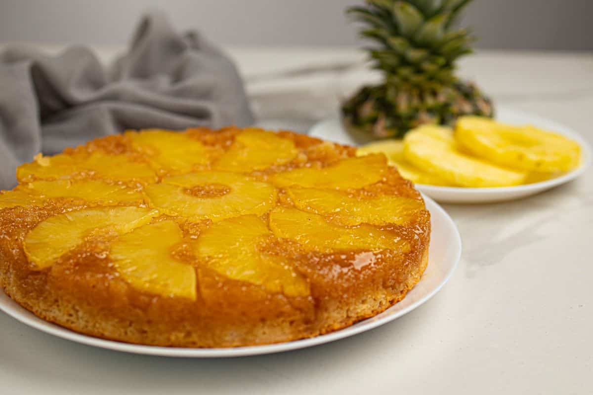 Delicious pineapple upside-down cake with caramelized pineapple slices on top. Perfect for dessert or special occasions.