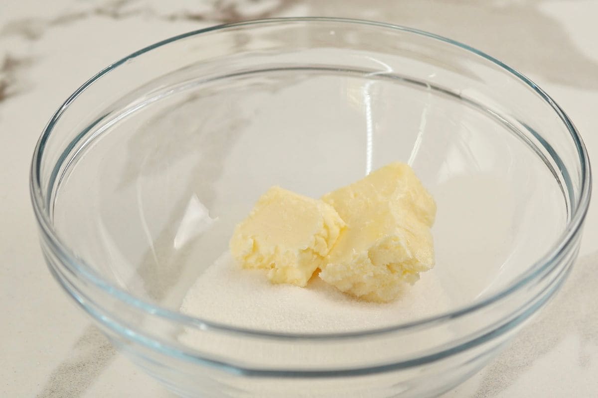 Creamy butter and sugar mixture in a glass bowl for baking.