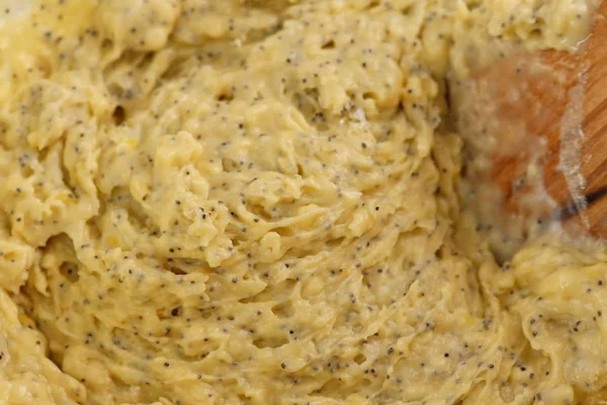 Creamy scrambled eggs mixed with black poppy seeds, ready to serve or cook further.