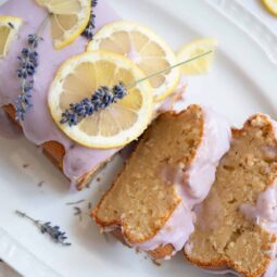 Luxurious lemon lavender pound cake topped with fresh lemon slices and lavender sprigs. Perfect for dessert or afternoon tea.