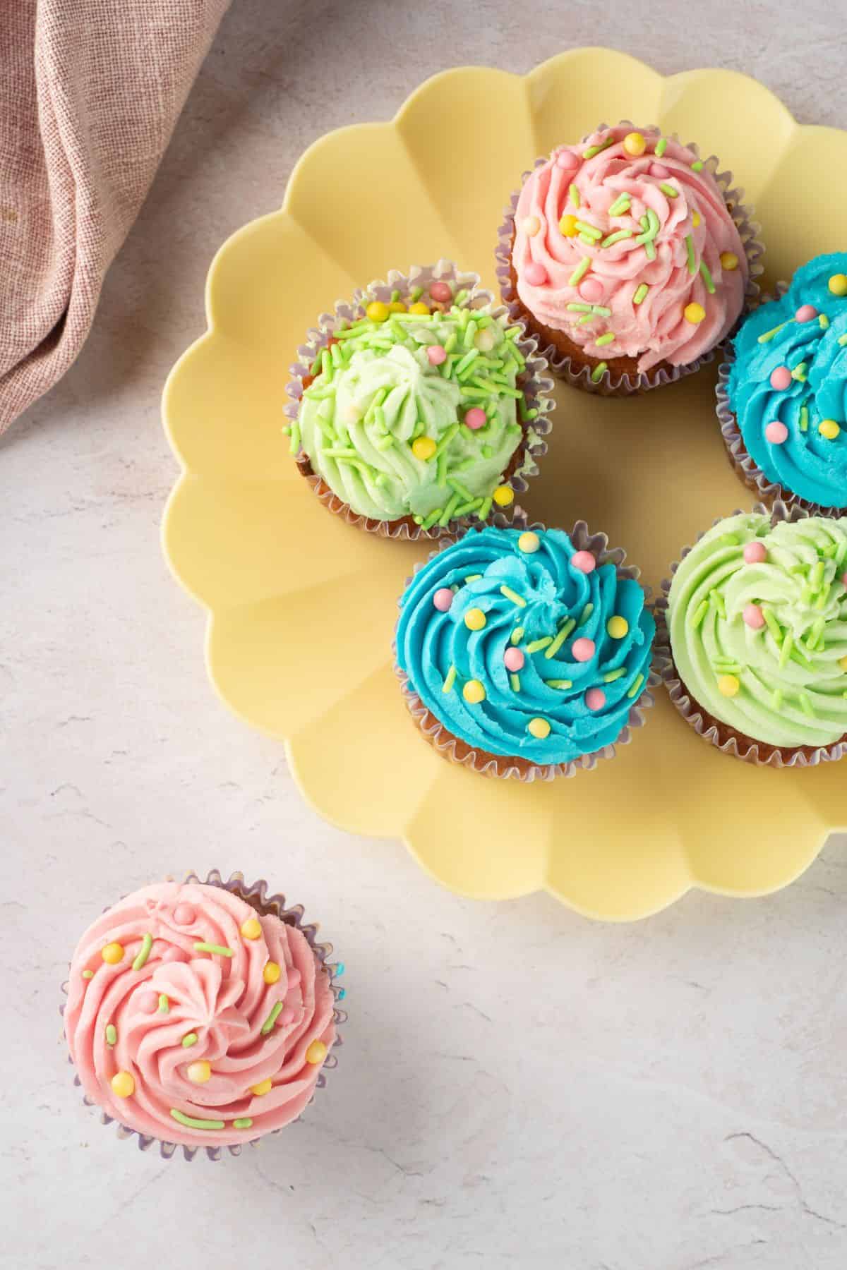 Vibrant cupcakes with pastel frosting and sprinkles, perfect for celebrations or parties.