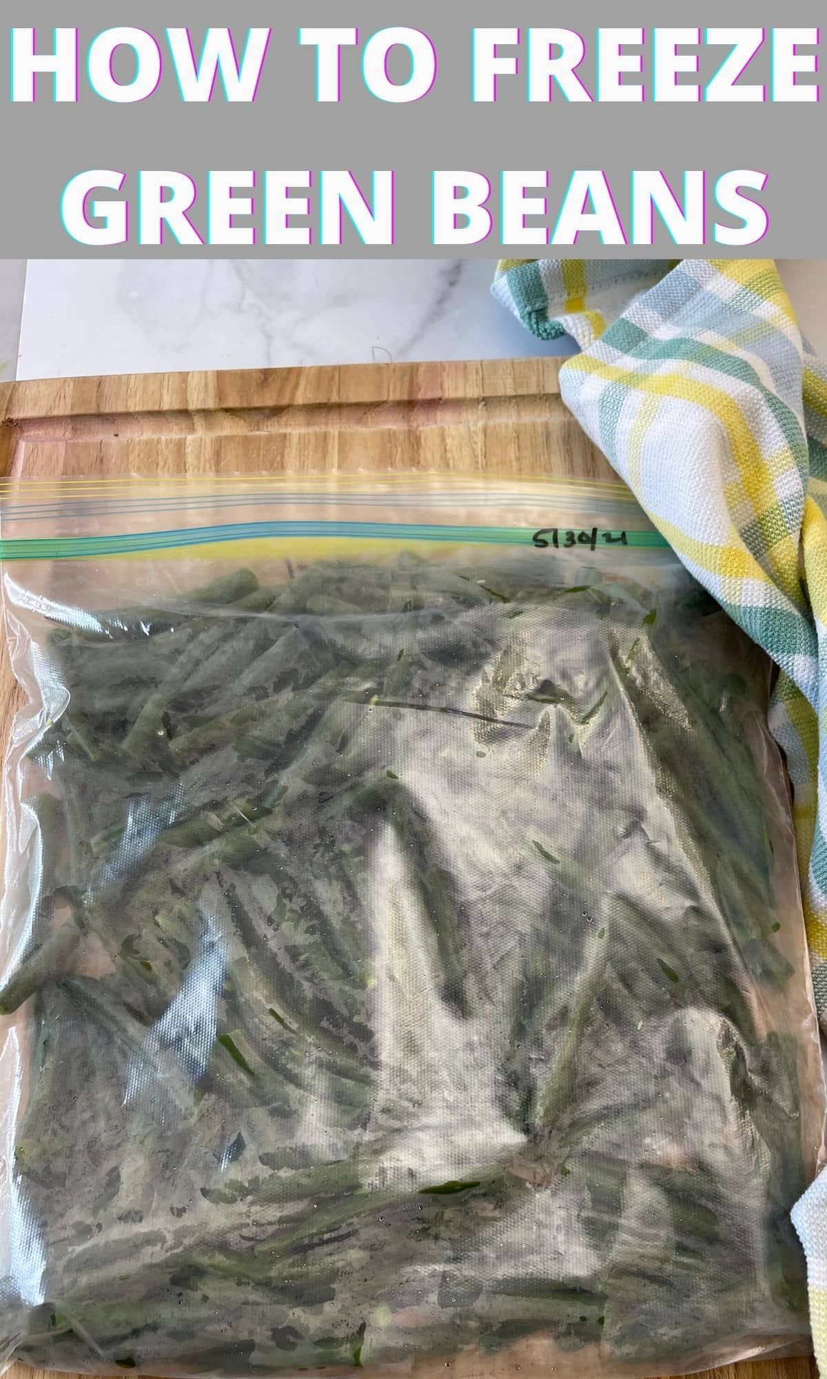 Plastic freezer bag filled with chopped green beans, with a date written on the top right