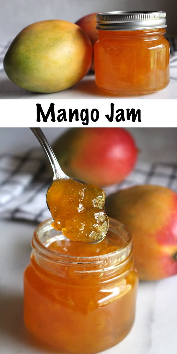 Spoon scooping golden mango jam from a small glass jar, with whole ripe mangoes in the background.