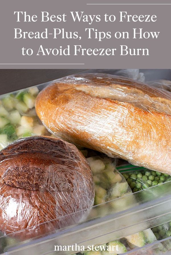 Two loaves of bread, one dark and one light, wrapped in plastic cling film and stored in a freezer drawer with bags of…