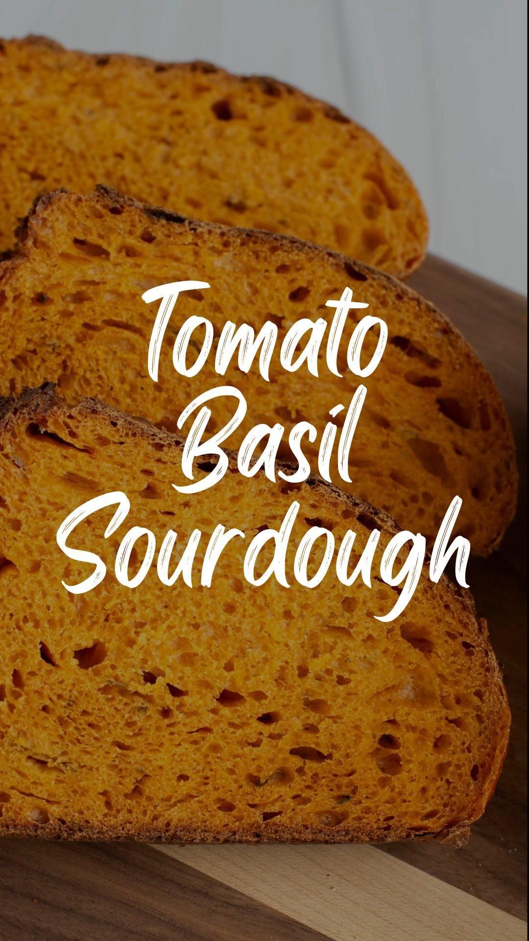 Three slices of orange-colored tomato basil sourdough bread, showing an open crumb structure.