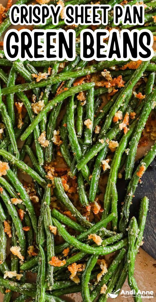 Close-up of baked green beans with many small toasted breadcrumbs scattered amongst them.