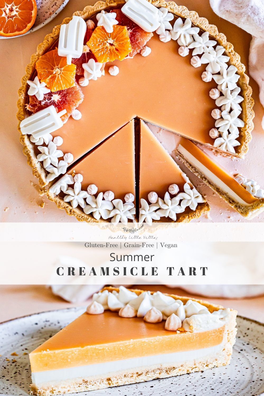 A round orange and white layered tart, partially sliced, garnished with meringue and citrus segments.