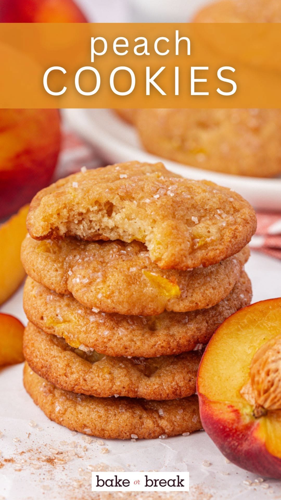 Stack of four peach cookies, one with a bite taken out, next to a halved peach