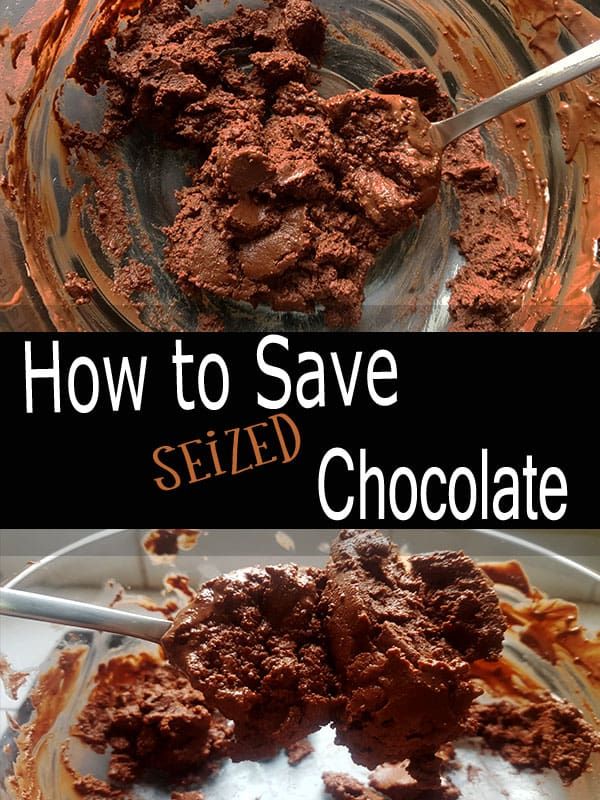 Lumpy, seized chocolate in a clear bowl with a spoon, highlighting its uneven texture.