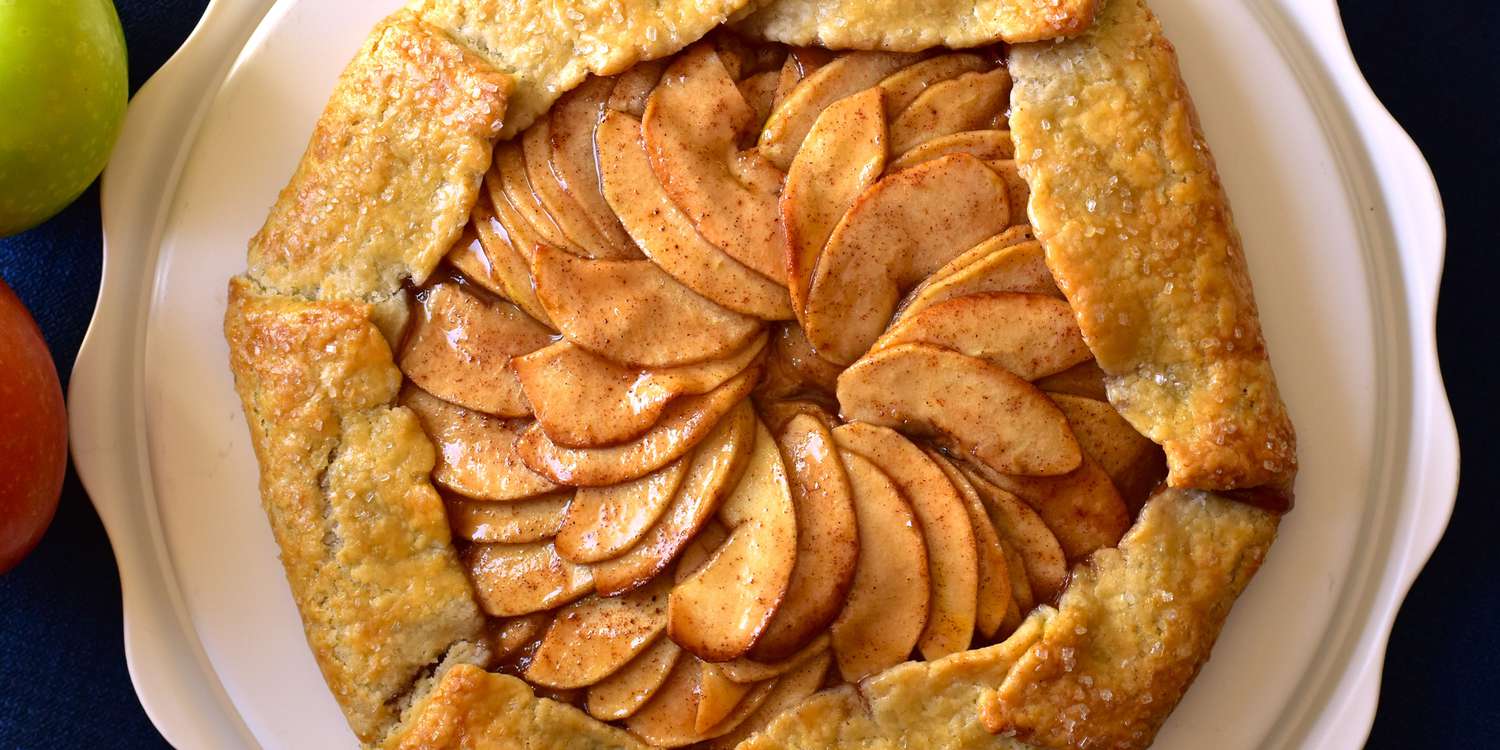 Baked apple galette with golden folded crust on parchment