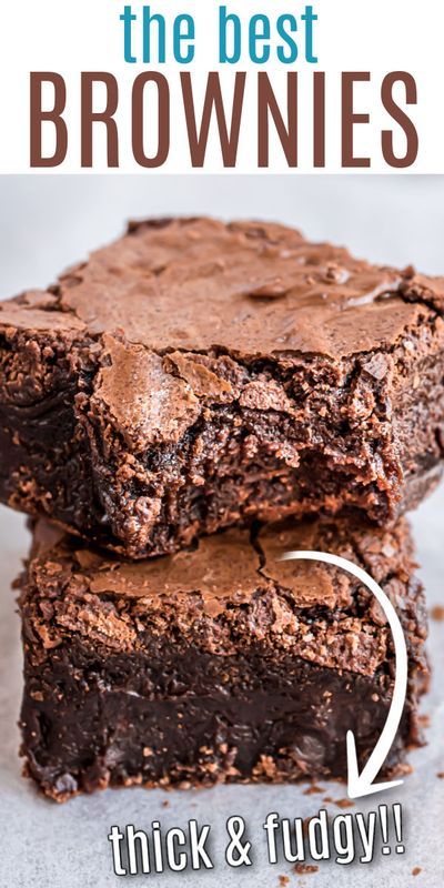 Two stacked squares of brownies with shiny, crinkled tops and dense, chocolatey centers.