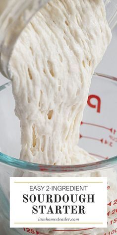 Thick, active sourdough starter pouring from one glass measuring cup into another