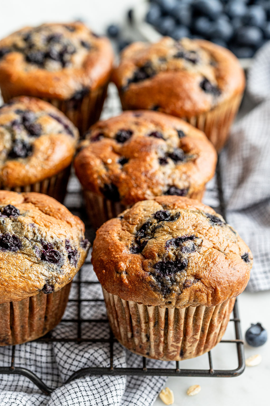 Blueberry oat muffins in paper liners on a plate