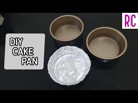 Two empty round baking pans next to a round, pan-shaped mold made from crumpled aluminum foil.
