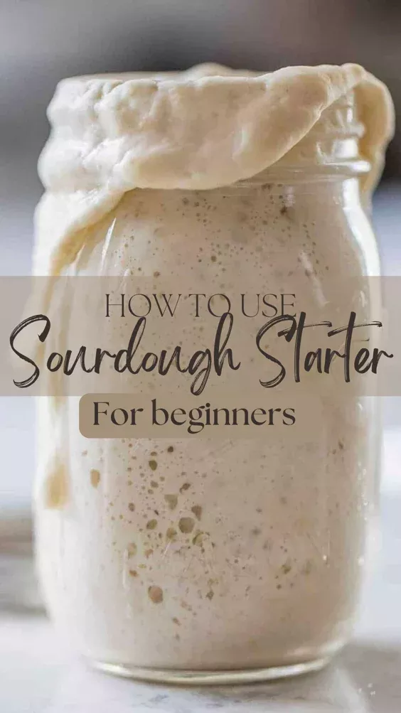 Active sourdough starter overflowing from a glass jar, covered with a cloth.
