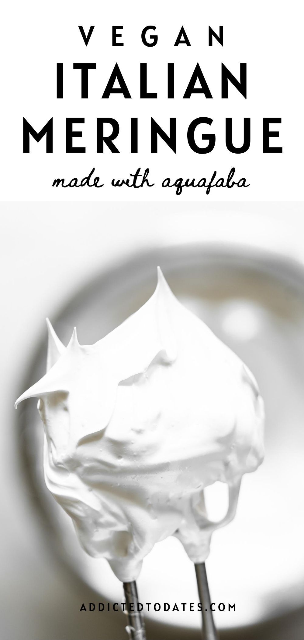Stiff white peaks of aquafaba meringue cling to a metal whisk attachment.