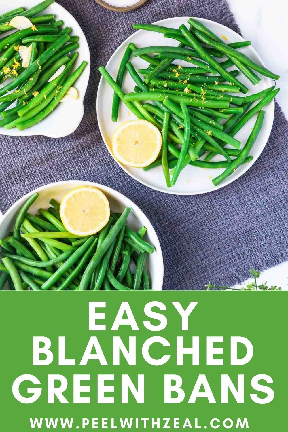 Plates and a bowl of bright green blanched green beans, some with lemon slices and garlic pieces.