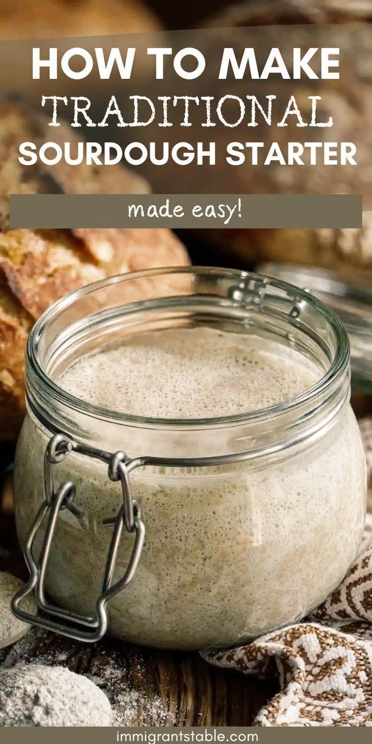 Close-up of a glass jar with an active, bubbly sourdough starter inside.