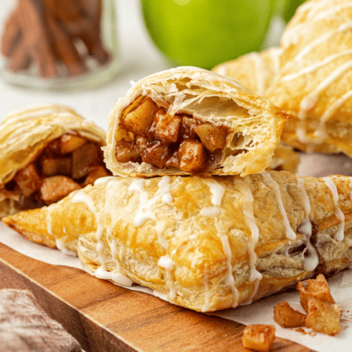 Puff pastry apple turnovers arranged on a plate