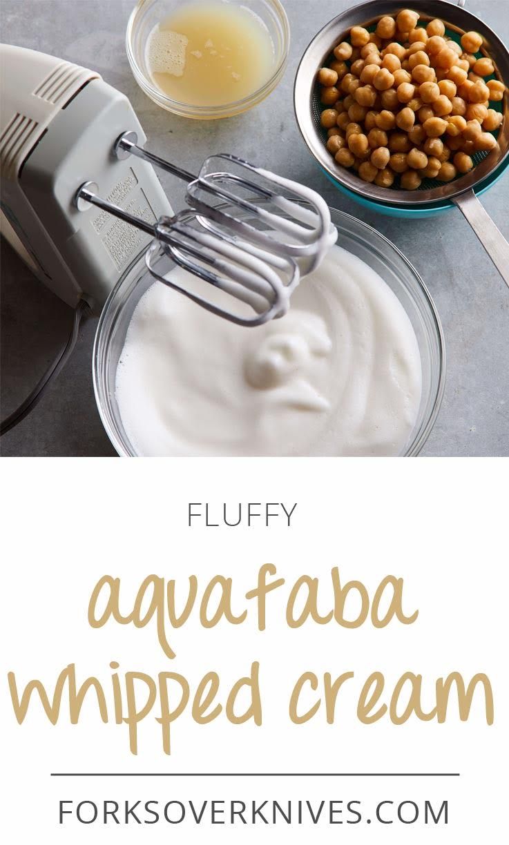 Electric hand mixer whipping light aquafaba foam in a glass bowl.