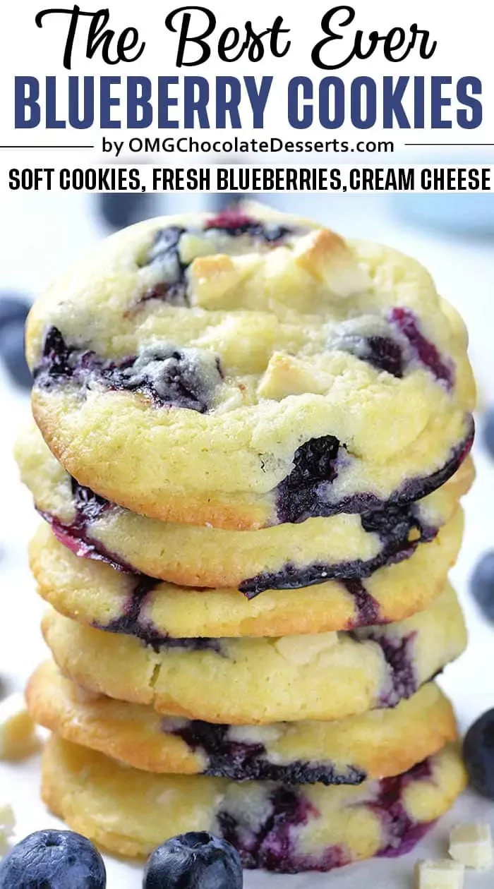 Stack of several blueberry cookies with white chocolate chunks and whole blueberries scattered around.