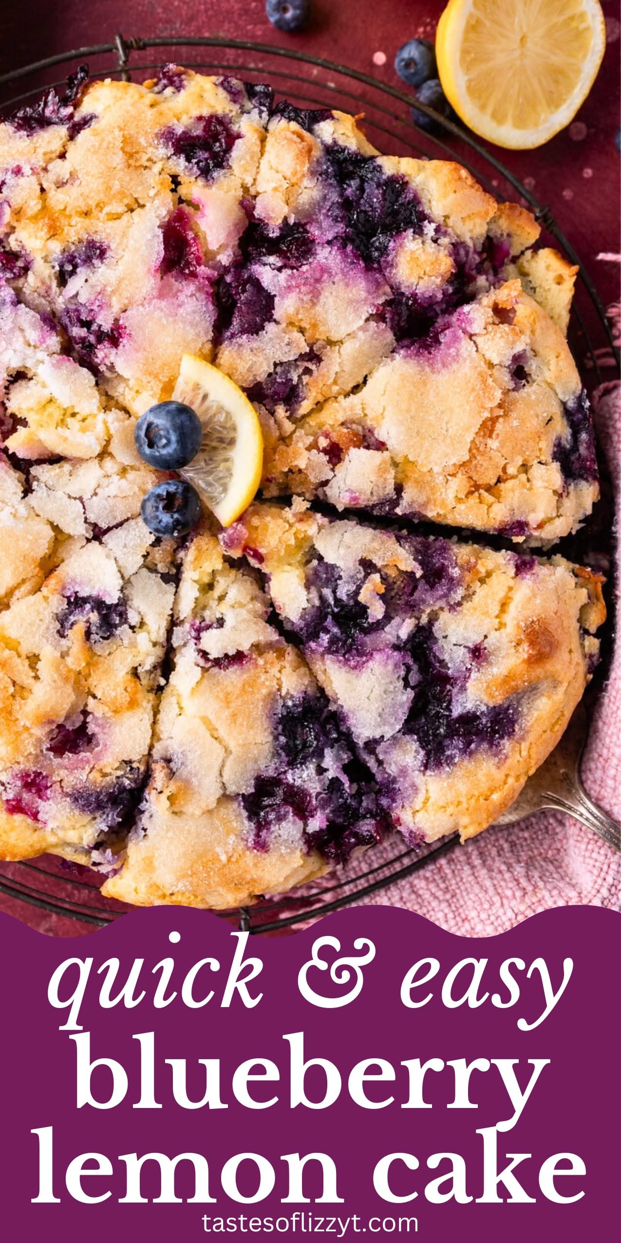 Blueberry lemon cake with a sugar topping, sliced into wedges, with fresh blueberries and a lemon wedge for garnish.