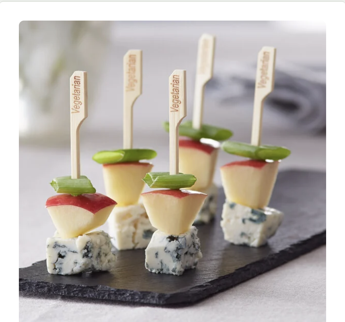 Several individual skewers with blue cheese cubes, apple slices, and green onion pieces, labeled 'Vegetarian'.