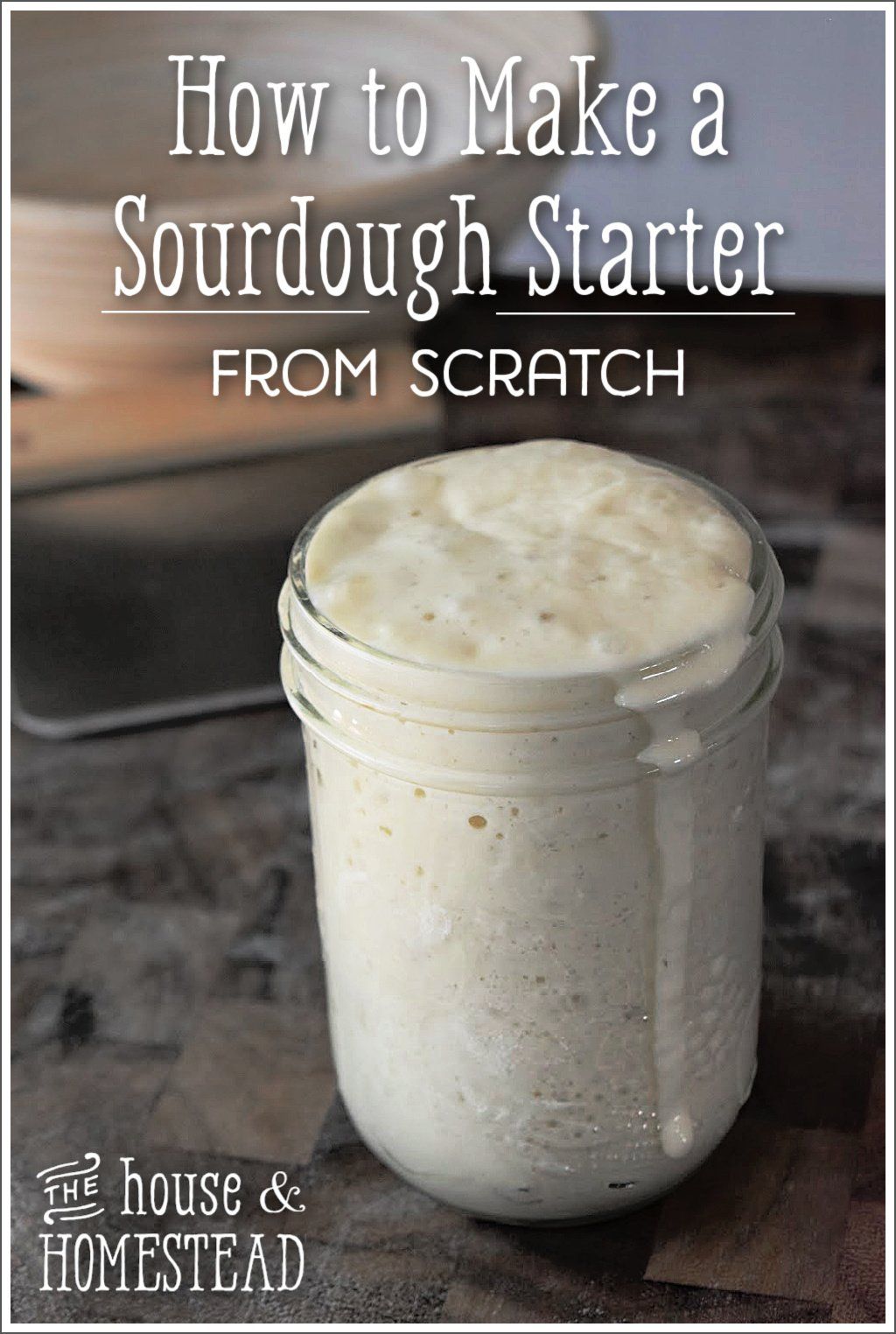 A glass jar filled with a bubbly, active sourdough starter, overflowing slightly at the top.
