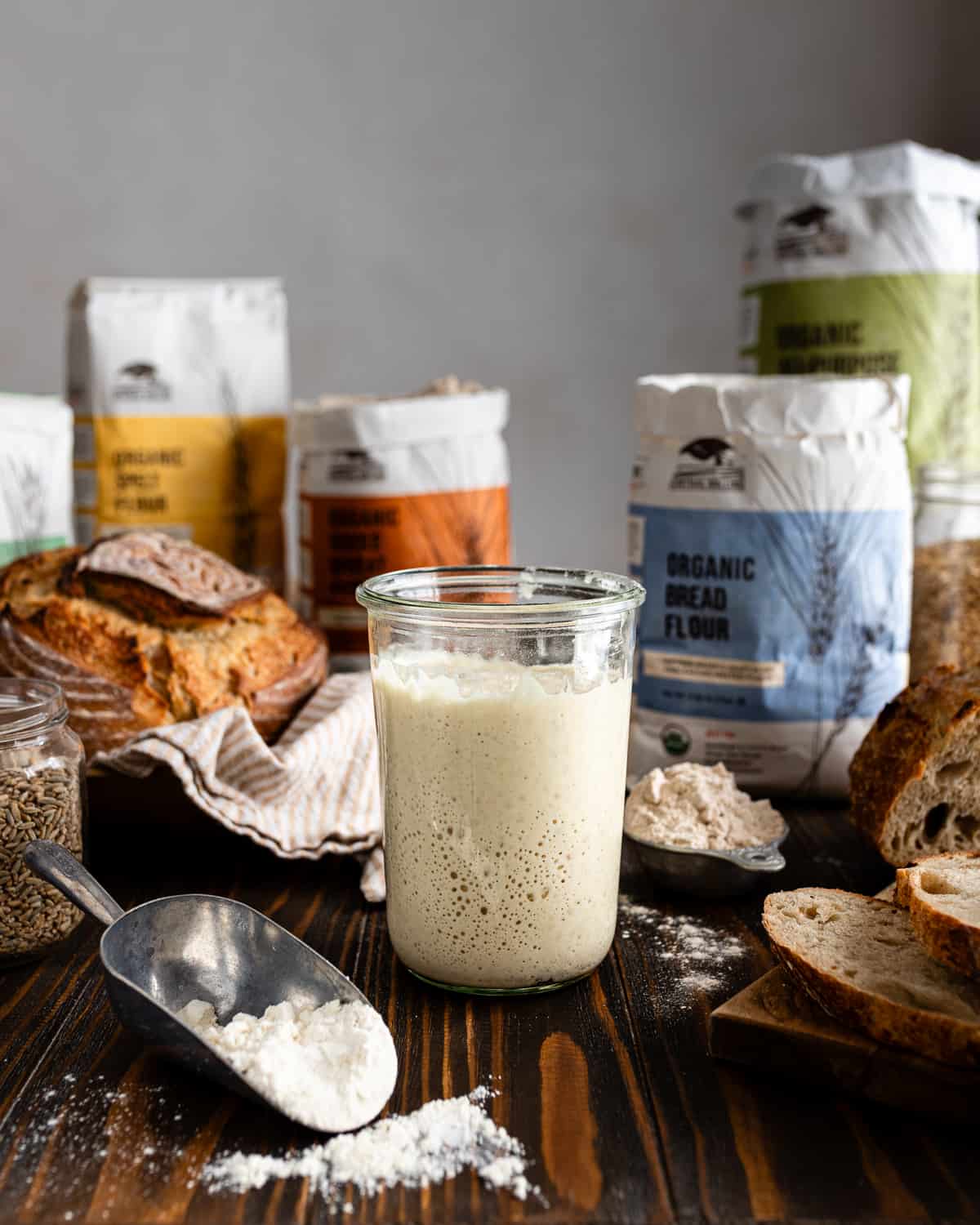 Bowls and containers of flour arranged on a work surface