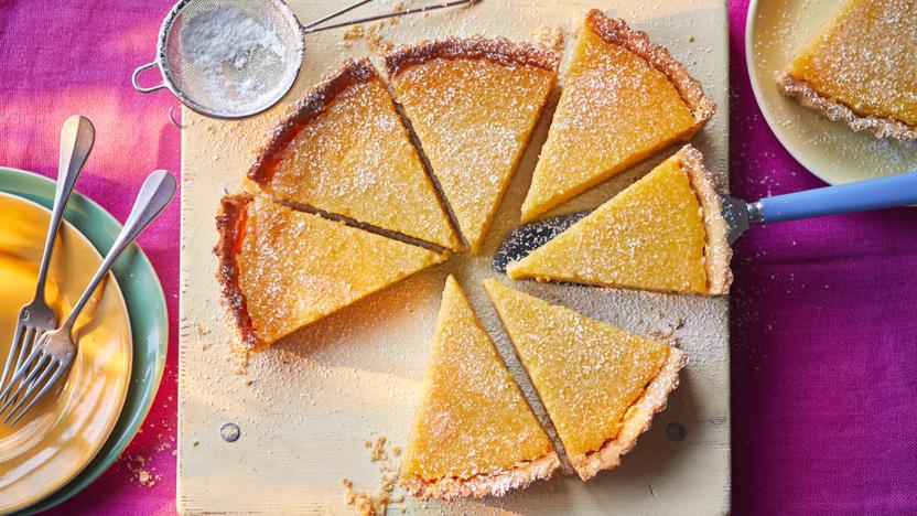 Lemon tart with a golden pastry crust and smooth pale filling.