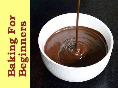 Stream of melted chocolate pouring into a white bowl, forming ripples