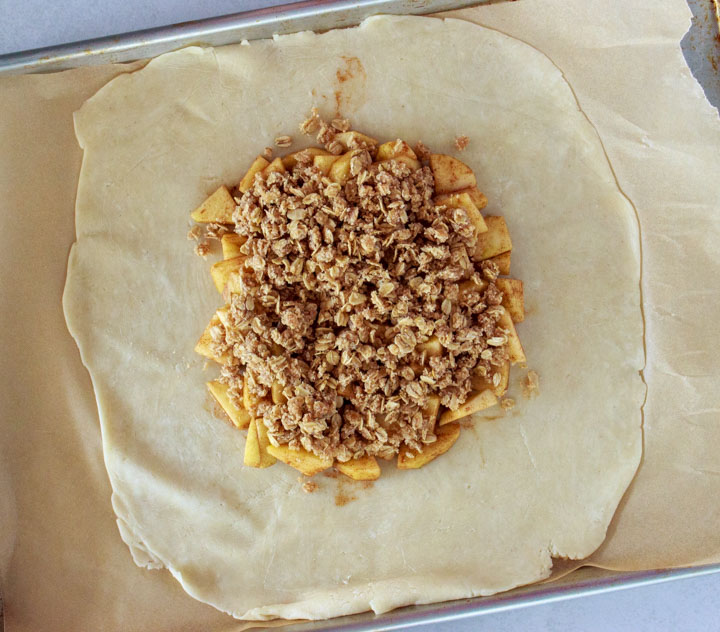 Slice of apple galette with crumb topping on a plate