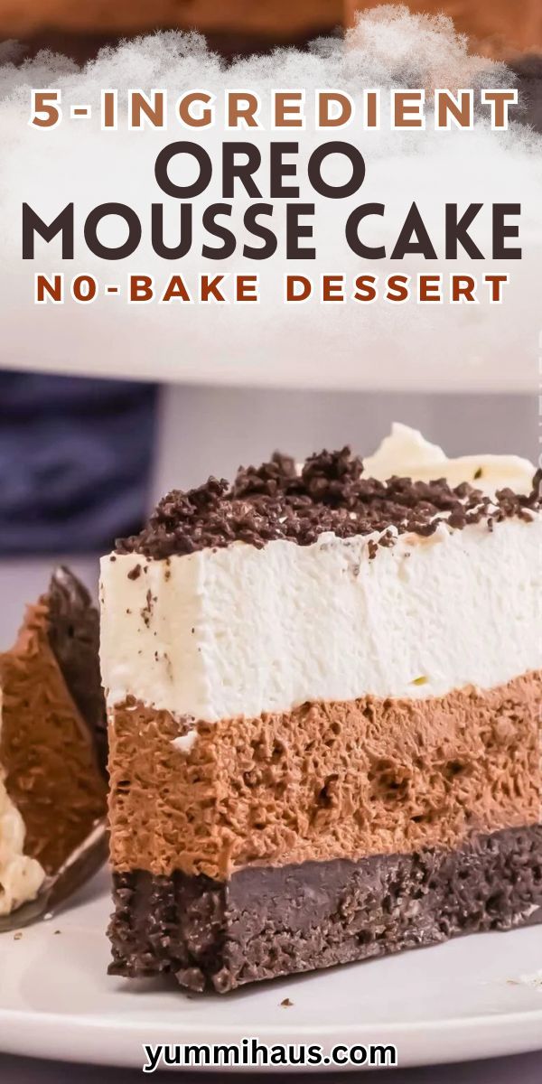 A slice of chocolate and vanilla layered mousse cake with an Oreo crumb base, topped with chocolate crumbles.