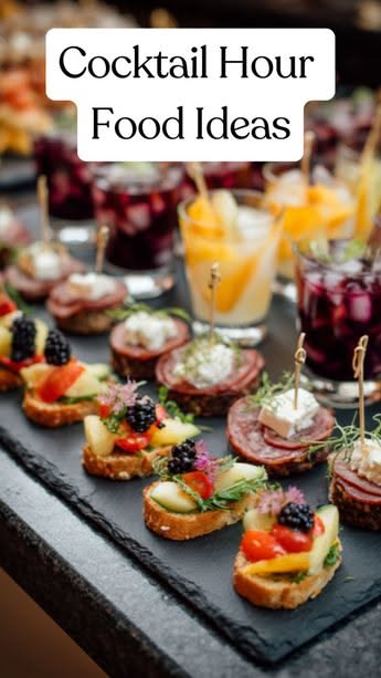 Small appetizers on a black slate tray: crostini with fruit, salami with cheese, and miniature drinks.