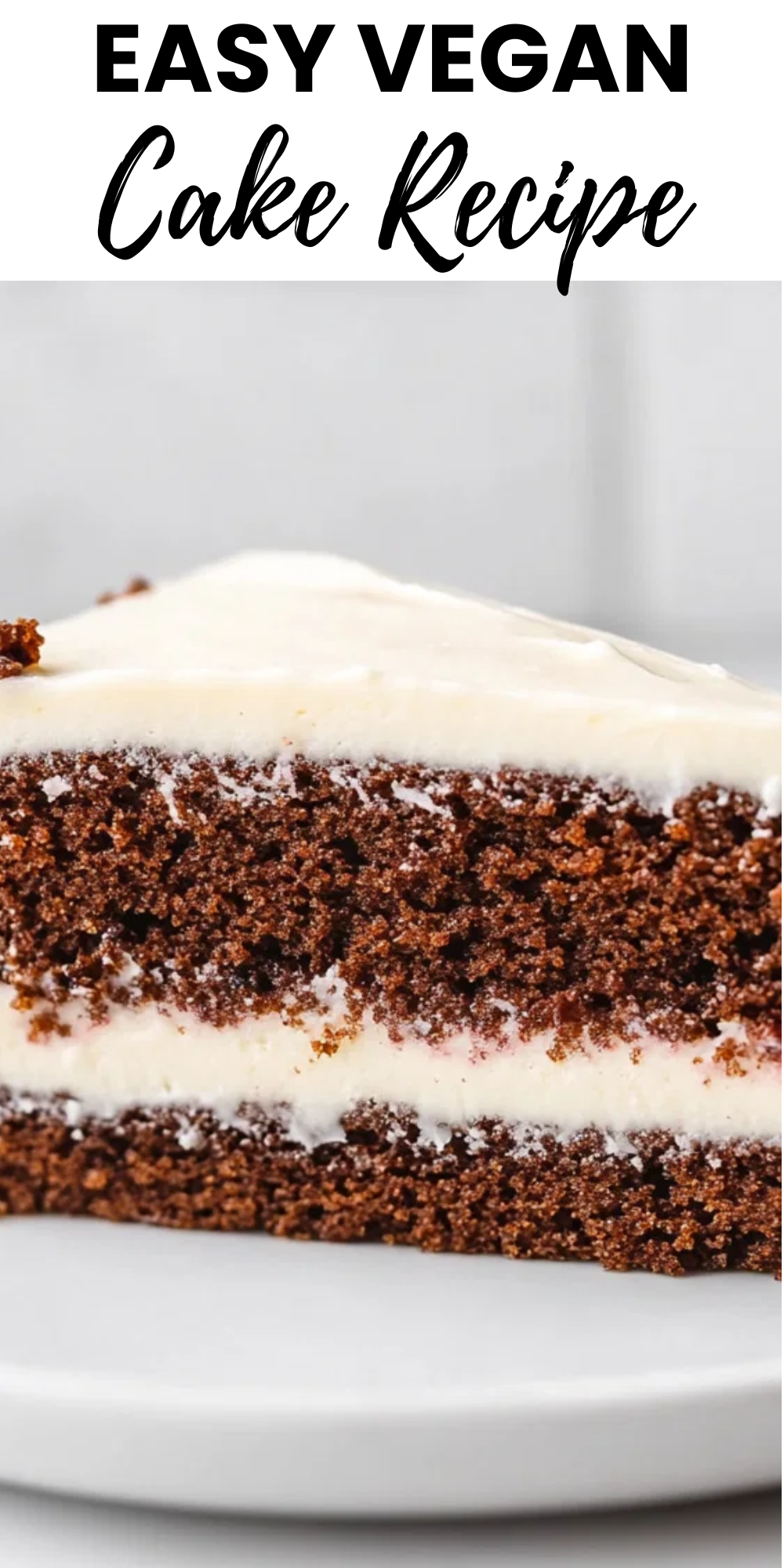 Close-up of a slice of chocolate layer cake with white frosting, resting on a white plate.