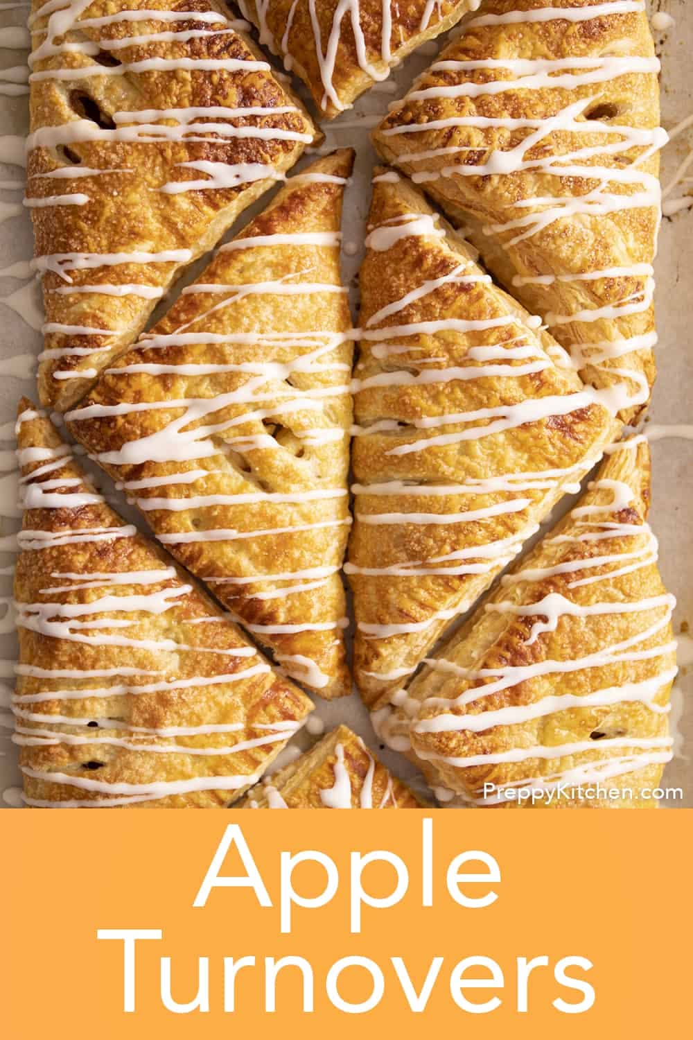 Several baked, golden-brown apple turnovers drizzled with white icing, arranged closely together.